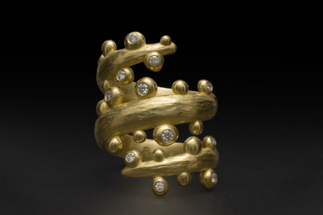 carved 18k gold seaweed spiral ring with diamonds