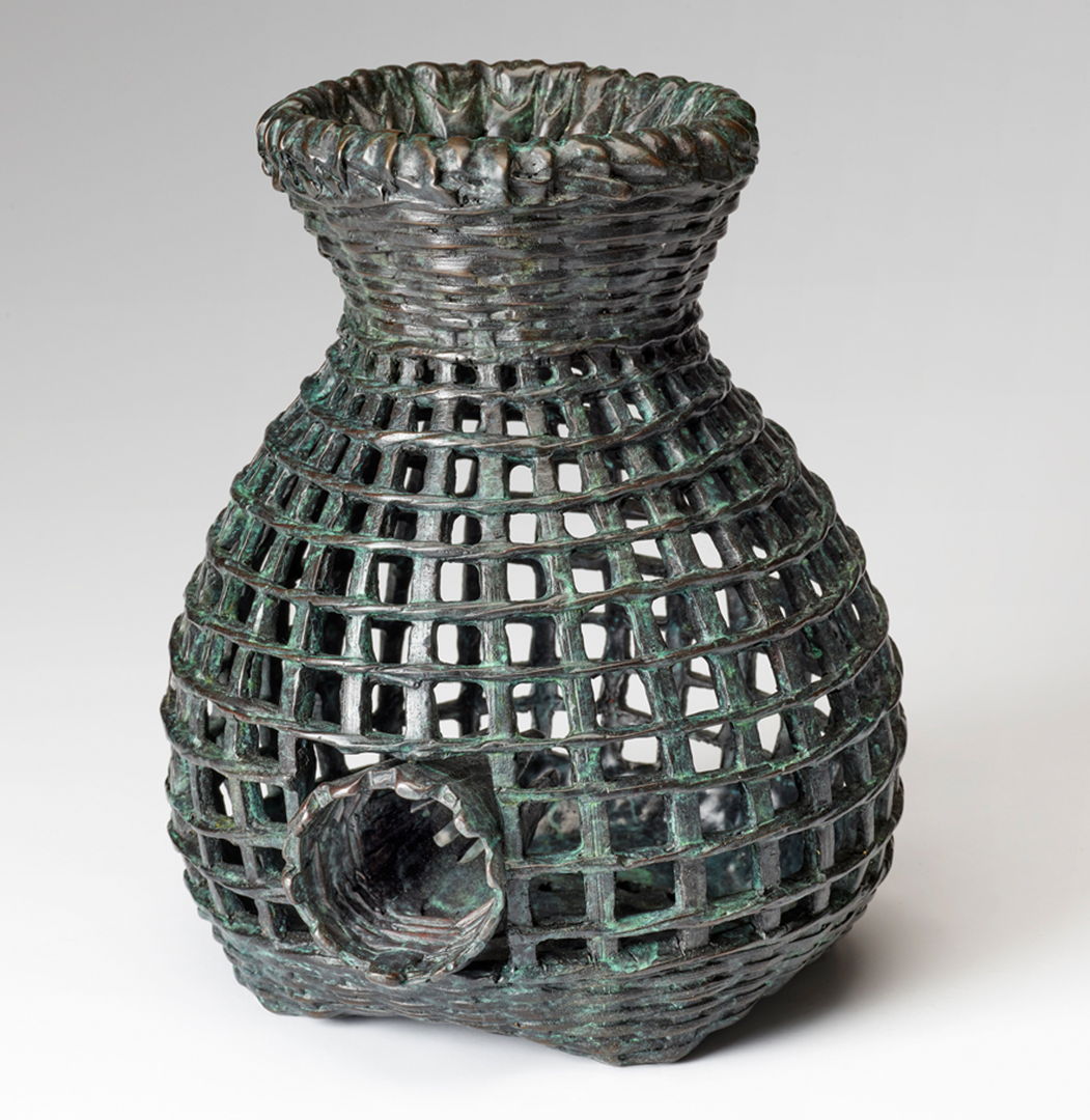 cast bronze fish trap basket with green highlights.