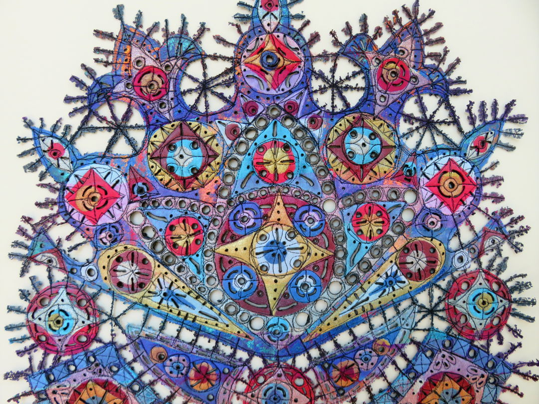 Detail of piece made up of colorful geometric designs connected to each other embellished with thread.