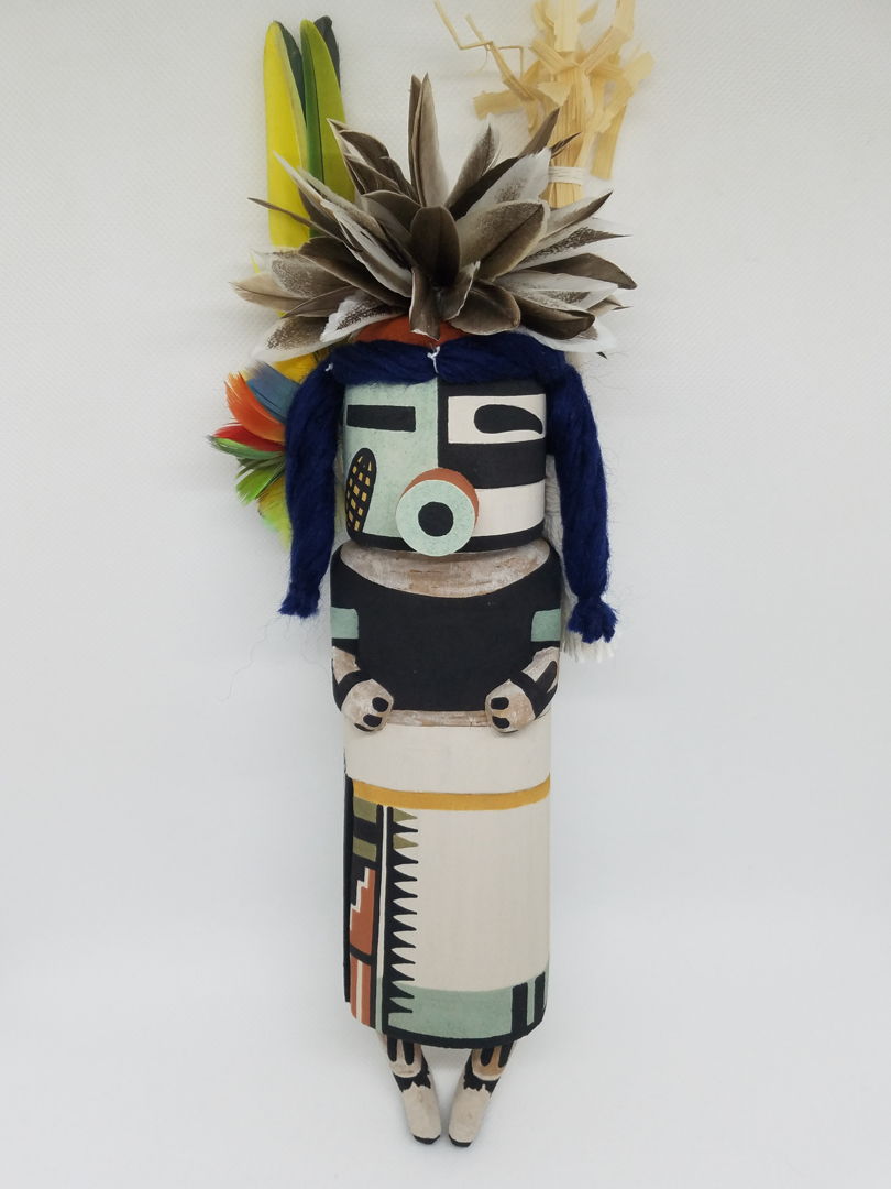 Carved from cottonwood root  painted with natural earth pigment paints. Other materials used  duck  parrot feathers  cornhusk and natural dyed yarn.