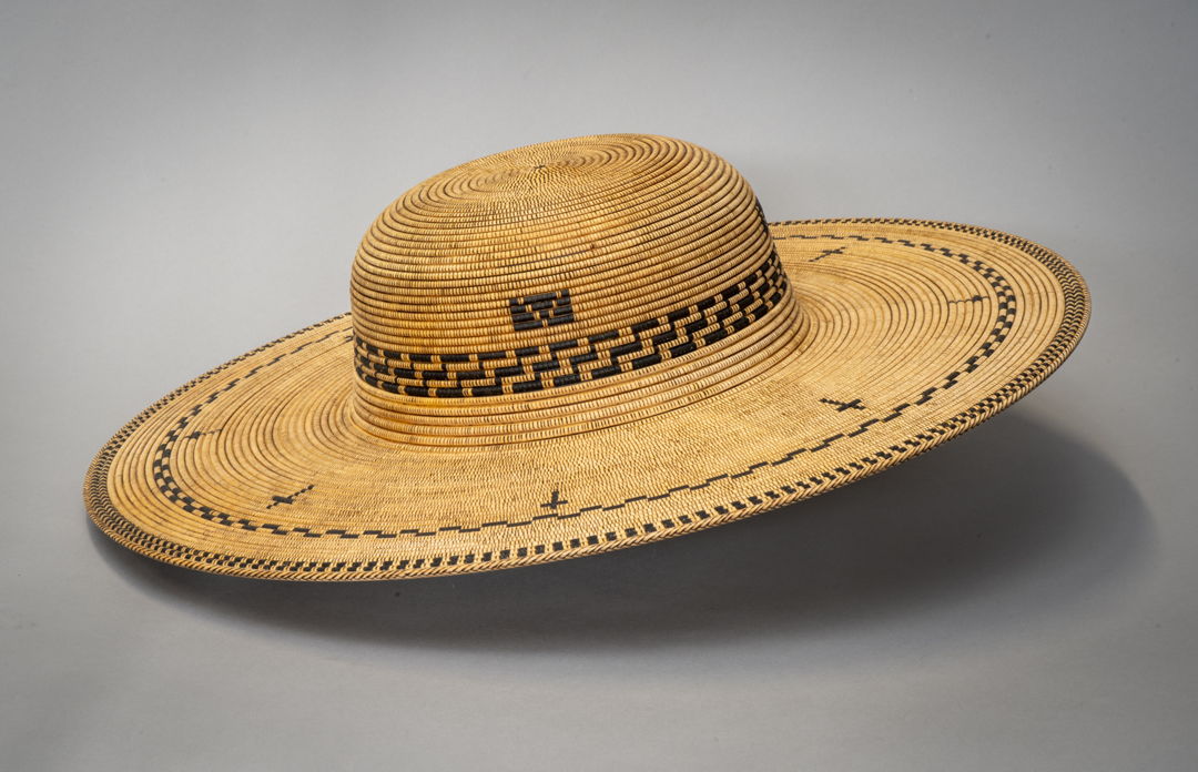A wooden hat made to resemble a woven hat made for a Padre from a Spanish Mission.