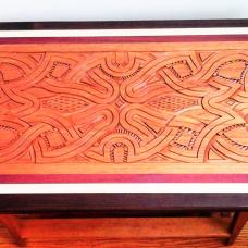 This carving design represents the currents of the rivers that are the center of life in the Amazon- they are the natural highway; food source- fishing  water for bathing and crop raising  and laundry; ever present as they flow beside and between our villages... now so threatened by climate change... seen with a table base made of cedar