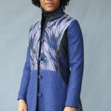 A Tailored coat sewn from coordinating patterned silk and cotton fabrics with handmade trim and buttons.