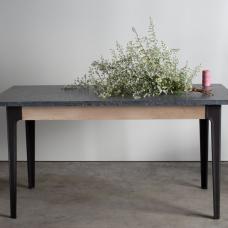 A smart kitchen prep table with a soapstone top  maple apron and cast iron legs.