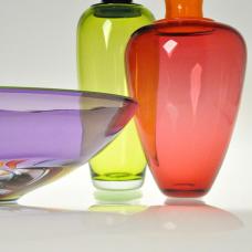 Blown Glass Vessels in transparent colored glass. These pieces are made by joining different sections of colored glass while hot  each finished with contrasting colored glass lip wraps.