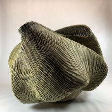 Hand-built pottery woven with dyed reed.