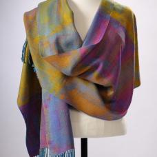 Polyvalence is a weaving technique that allows for large patterns without sacrificing good fabric structure. The pattern is scattered into twills and rearranged twills. There is a lovely layering effect that shimmers.This shawl has gold  orange  and pink wefts on a multi-colored hand-dyed warp.