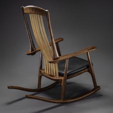 Rocker in California walnut with Spinneybeck leather seat. Backslats are red elm. This chair has a unique back support system developed by us. We call it the &amp;quot;Floating Back&amp;quot; and it has an ergonomic lower back support that moves and massages. It can be customized and fitted for comfort.