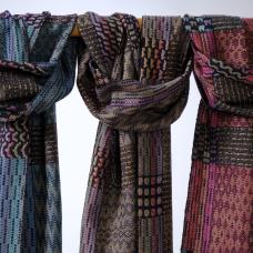 Two patterns are uniquely combined here. Color and weave effects make large graphic patterns and multi-colored warps woven with one shuttle make an iridescent pattern called echo weave.