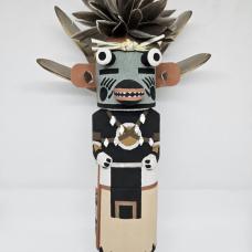 The Blue Badger Kachina is one of many badger kachinas that appear on Hopi during the winter and summer months  he is a symbol of strength  healing and protection. The blue badger is carved out of dried aged cottonwood root  painted with natural earth mineral paints that I hand collect and process myself. Duck feathers  quail feathers and shells are used to complete the blue badger kachina.