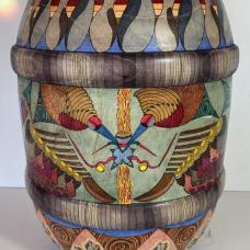 This barrel shaped vessel came from sassafras wood. The middle surface design was created directly onto the surface without any preparatory pencil marks  lending the process a free range for my imagination. The upper and lower portions were designed using pencil lines beforehand to support relative uniformity of the repeats. This design focuses on the intersection between outer life and inner life