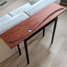 A three-dimensional landscape shimmering in the light of a full moon is created from circles drilled into the bubinga table top and underlaid with aluminum. The top floats above a base constructed from ebonized ash and anodized aluminum tubes. Limited edition of 12