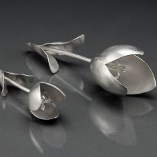 Each tulip is hand fabricated from flat sheets of sterling silver. Each pedal was hammered  curved  and shaped. All the parts were then soldered together. This resulted in the construction of each form becoming like three dimensional jigsaw puzzles. The flowers were then sanded to a silky  satin finish. I wanted to make beautiful  sculptural objects based on tulips. They're soft  minimal  and occupy space. Small: 6&amp;quot; long. Large: 9&amp;quot; long.