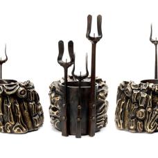 another piece in he engorged Eden series  the main body is made of brass and stainless steel with a polished rim and the candle holders are forged steel