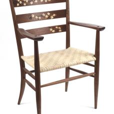 Walnut ladderback arm chair with dogwood marquetry on the back slats. The veneer marquetry is all cut  shaded and assembled by hand. The rear legs are steam bent and the seat is hand-woven reed in a herringbone pattern.