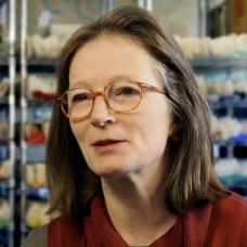 Female with brown shoulder length hair and glasses