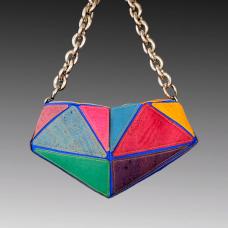 purse made up of different triangular fabric pieces with large gold chain