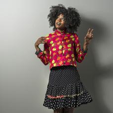 model with short floral jacket and polka-dot skirt