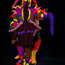 full body suit of bright colors on black background