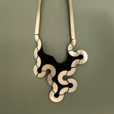 Inspired from trails of animals on the sand  crafted with Gold metallic quality leather  this sculptural piece plays with puzzle-like patterns. Easy to wear magnetic clasp.
