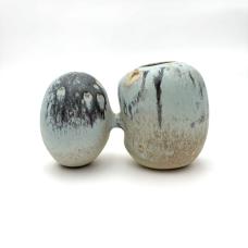 Imagined relationship between rock forms. Double shaped vessel with rock like glaze coloration that breaks from pale browns to navy blue. Soda fired piece with multiple glazes. Stoneware and glaze.