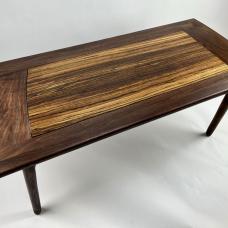 Sculpted coffee table in walnut and zebrawood