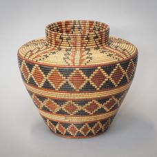 A wood basket made to resemble a Yokuts Bottleneck basket. The piece is turned on a wood lathe  then embellished with India Ink and a burning pen.