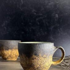Golden sands mugs are thrown from a dark red clay body and decorated with a blend of wild clay slips  sand  volcanic ash from Iceland's Katla volcano  and underglaze. Inspired by Iceland’s Skarðsvík Golden Beach with its sparkling sands and browned basalt columns.