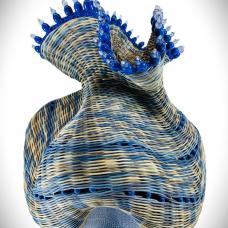 Hand-built pottery base woven with dyed reed and embellished with glass beads and a leather rim.