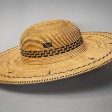 A wooden hat made to resemble a woven hat made for a Padre from a Spanish Mission.